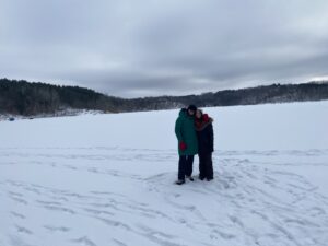 Two people standing on a frozen lake